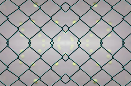 seamless pattern of cage of tennis court with tennis court blurred background