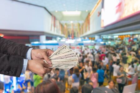 Businessman offered the money on the Abstract blurred photo of store blur with customer bokeh backgroundの写真素材