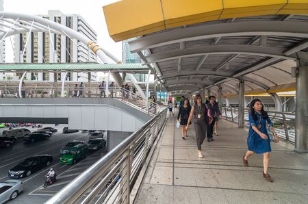 BANGKOK - JUNE 25, 2015: Undefined People are walking on the pedestrian bridge which is Bangkok landmark at Chongnonsi SkyBridge at morning for attendance on June 25, 2015 in Bangkok, Thailand.のeditorial素材