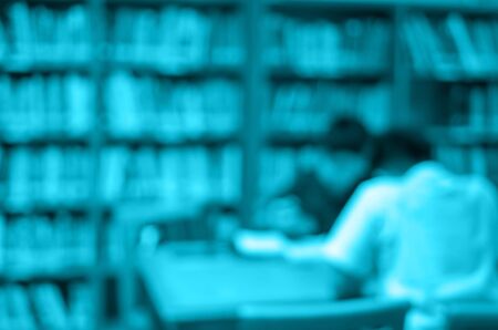 abstract Blurred photo of student reading in library, blur backgrounds concept.の写真素材