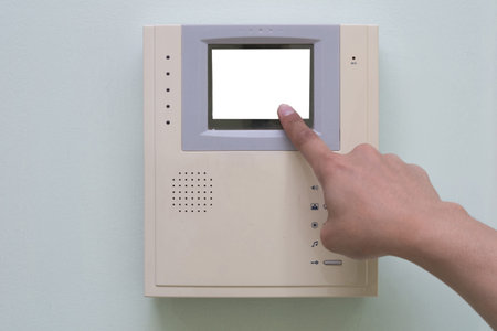 Human finger pushing button of video intercom equipment
