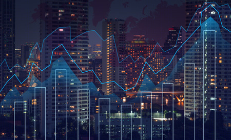 Trading graph on the cityscape at night and world map background,Business financial conceptの素材 [FY31044923115]