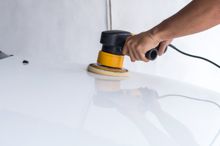 Polishing the white car with reflection, car care conceptの写真素材