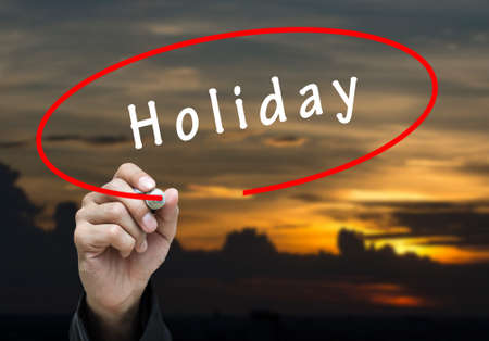 Man Hand writing Holiday by black marker on visual screen. Business conceptの写真素材