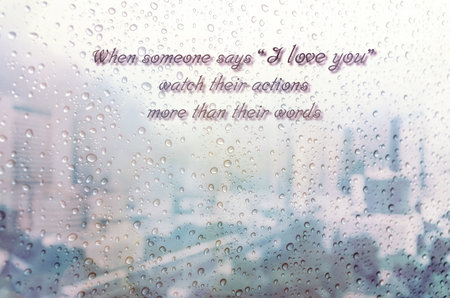 Waterdrops on a glass surface windows with i Love you qoutes on cityscape background