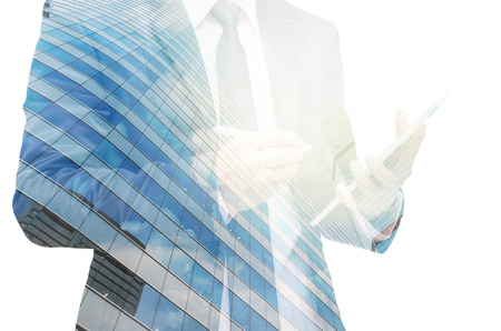 Double exposure of businessman with cityscape building glassの写真素材
