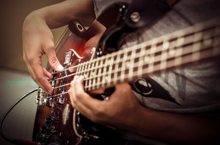 Closeup hands playing guitar