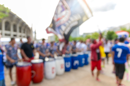Abstract blurred photo of fan sport with drum music instrument for cheer and flag of team at stadium, sport background conceptの写真素材