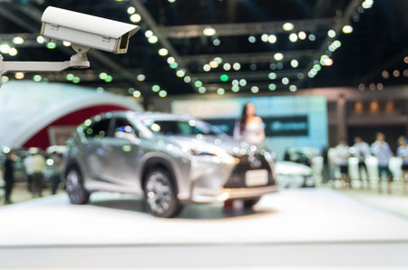 CCTV security camera on monitor the Abstract blurred photo of motor show, car show room