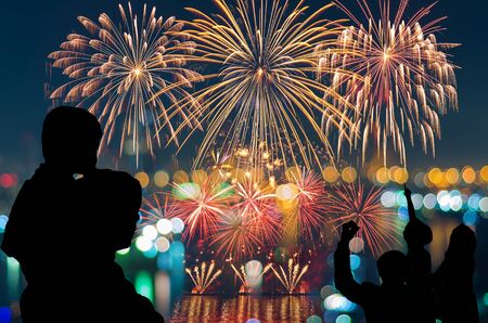 The people looks Fantastic festive new years colorful fireworks on cityscape blurred photo bokeh,project success, holiday concept, family conceptの写真素材