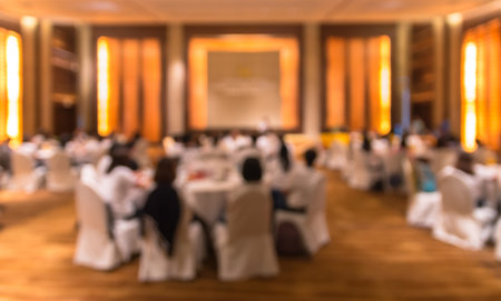 Abstract blurred photo of conference hall or seminar room with attendee backgroundの写真素材