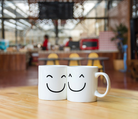 Two happy cups on coffee store blur background, valentine and business conceptの写真素材