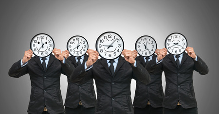 set of 5 picture of Asian businessman holding the clock to close his face with smile motion each time on white backgroundの写真素材