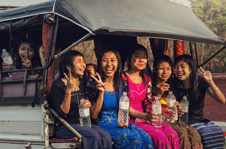 MANDALAY, MYANMAR - MARCH 11, 2016 : Undefined Women on the car playing water in pre water festival(Songkran festival) on the march 11, 2016 at Mandalay, Myanmarのeditorial素材