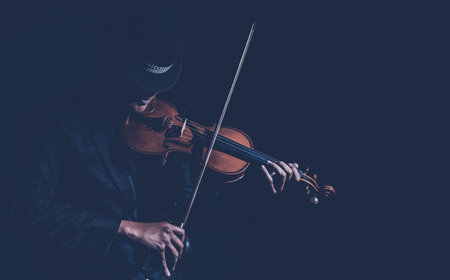 Violin player in dark studio, Musical concept