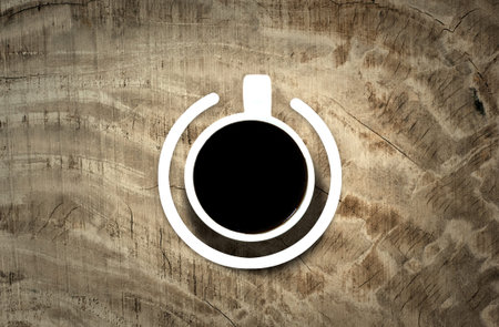 Coffee cup with power-on symbol over the wooden background. Energy and active concept