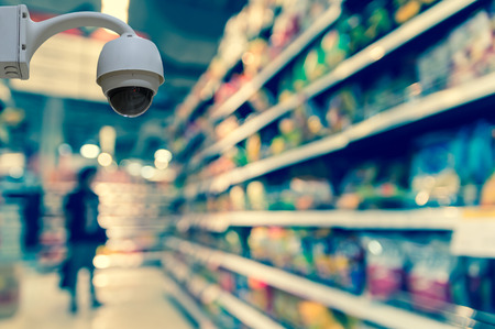 Security camera monitoring on the Abstract blurred photo of store in department store bokeh background, business shopping conceptの写真素材