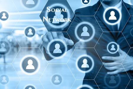 Businessman touching the Social network icon on Abstract blurred photo of store in department store bokeh background, Business technology conceptの写真素材