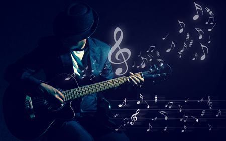 Musician playing the guitar with music notes on black background,music conceptの写真素材