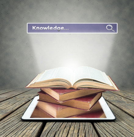 Tree growing from the old books over tablet on with browsing of Internet searching "knowledge" bar backgound, Education and knowledge with technology conceptの写真素材