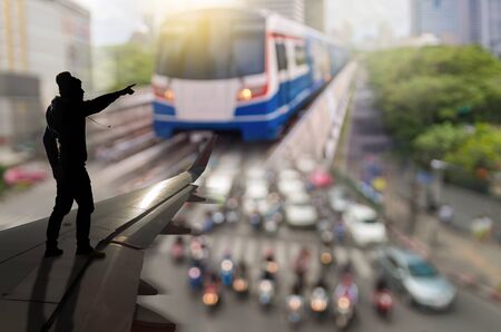 silhouette of man who pointing photo blurred of traffic jam on airplane wing, business traffic conceptの写真素材