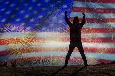 silhouette of a man who show hands over the Multicolor Fireworks Celebrate over the United state of America USA flag background, Independence day conceptの写真素材