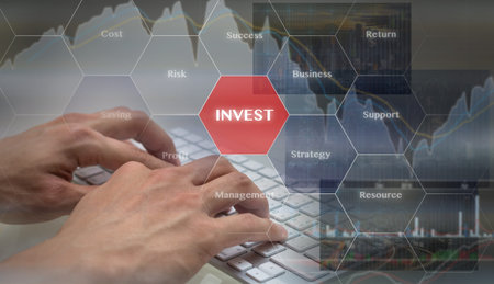 Closeup hand typing the keyboard over the Trading graph on the cityscape background, Business financial conceptの写真素材