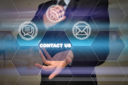 Businessman with show hand posture to present the Contact us icon on the Abstract blurred photo background, Business customer service conceptの写真素材