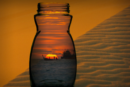 Sunset on the sea with colorful sky and fishing boat in the glass over the sand dunes photo blurred background, abstract photo contrast conceptの写真素材
