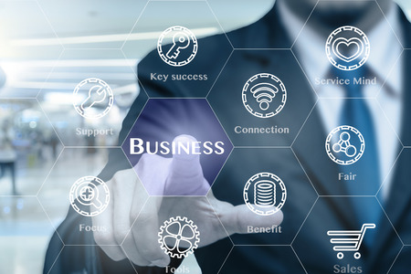 Businessman touching the Business icon with business success tools on the Abstract blurred photo of store in department store bokeh background, Business technology conceptの写真素材