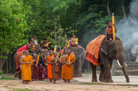 SURIN, THAILAND - JUNE 26: Unidentified Monks and Buddhists riding the elephants walking with incense around a temple on JUNE 26,2016, in SURIN Province, Thailand. at Wat Ming Jiangのeditorial素材