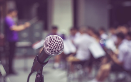 Microphone over the Abstract blurred photo of classic music band when rehearsal, musical concep, seminar meeting conceptの写真素材