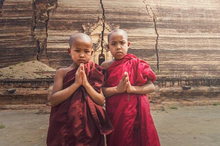 Two Buddhist novice are praying at Mingun Pahtodawgyi, bagan, mandalay, myanmar, public domainの写真素材