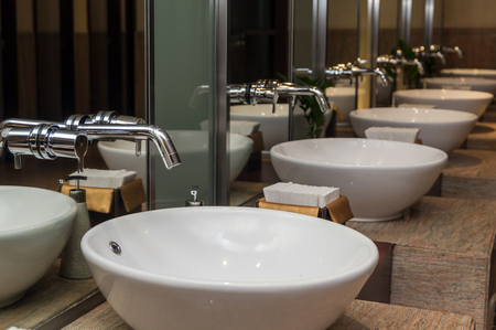 Chrome faucet with washbasin in modern bathroomの写真素材