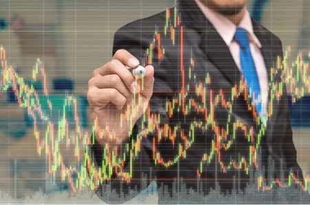 businessman drawing the stock graph with stock market exchange over the trading room , business...