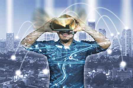 Double exposure Asian Man wearing virtual reality with Network connection line between building over...
