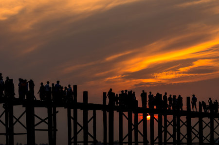 Sunset with silhouettes of many people on the U-Bein Bridge is the longest. in Amarapura ,Mandalay ,Myanmarの写真素材