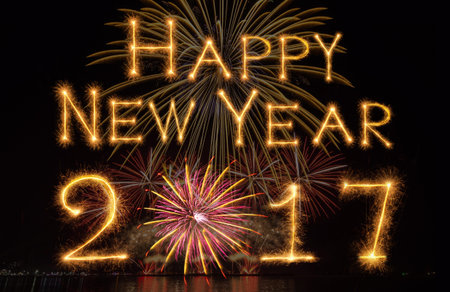Happy new year 2017 written with Sparkle firework on fireworks with dark background, celebration and...