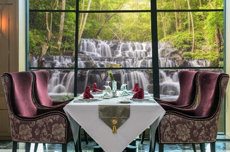 Luxury restaurant set over windows glass of the view of Beautiful waterfall in the forest, dicut each elementsの写真素材