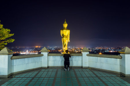 Buddha standing on a mountain at twilight time at Wat Phra That Khao Noi, Nan Province, Thailand, public domainの写真素材