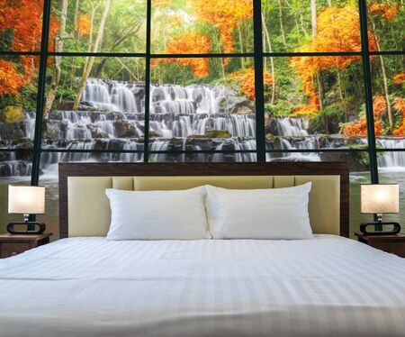 Luxury Interior bedroom with windows glass beside Beautiful waterfall in the deep forest, relax and holiday concept, dicut each elementsの写真素材