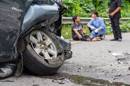 NAN, THAILAND - OCT 25 : Car crash accident on the street of mountain over the photo blurred of Undefined casualty with nurse on the road on October 25, 2016 in Nan province, Thailandのeditorial素材