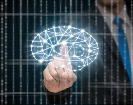 Businessman hand holding the brain over the matrix digital number technology on dark background, technology and innovation conceptの写真素材