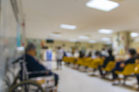 Abstract photo blurred of hospital background with patient sitting chair and waiting seat for see doctor, Hospital and physician conceptの写真素材