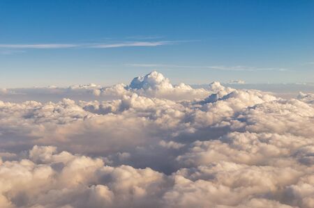 aerial view of clouds over the blue sky, a view from airplane windowの写真素材