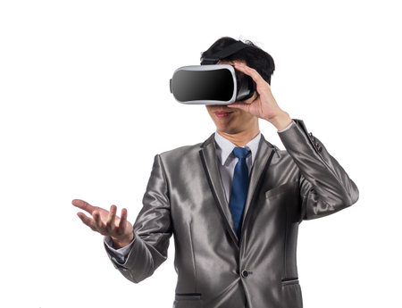 Asian Businessman wearing virtual reality on white background, include clipping path