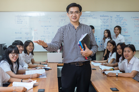 Portrait of Asian teacher Giving Lesson to group of College Students in the classroom, University education conceptの写真素材