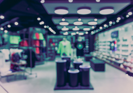 Abstract blurred photo of fashion store in shopping mall which have clothing bag and shoes, shopping conceptの写真素材