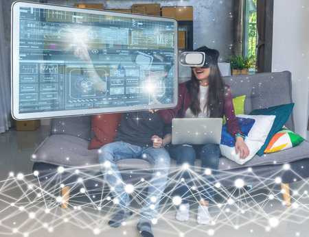 Asian young man and woman in casual clothes wear the virtual reality glasses are watching and...
