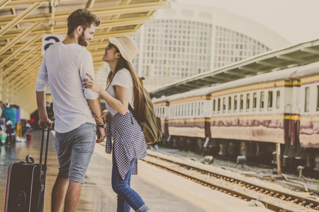 Couple of Multiethnic Travellers are looking together at the train station, Travel and lover conceptの写真素材